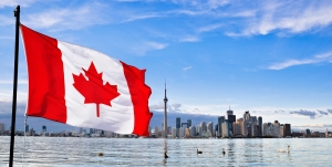 Canada Immigration - Canada Flag over a Canadian City
